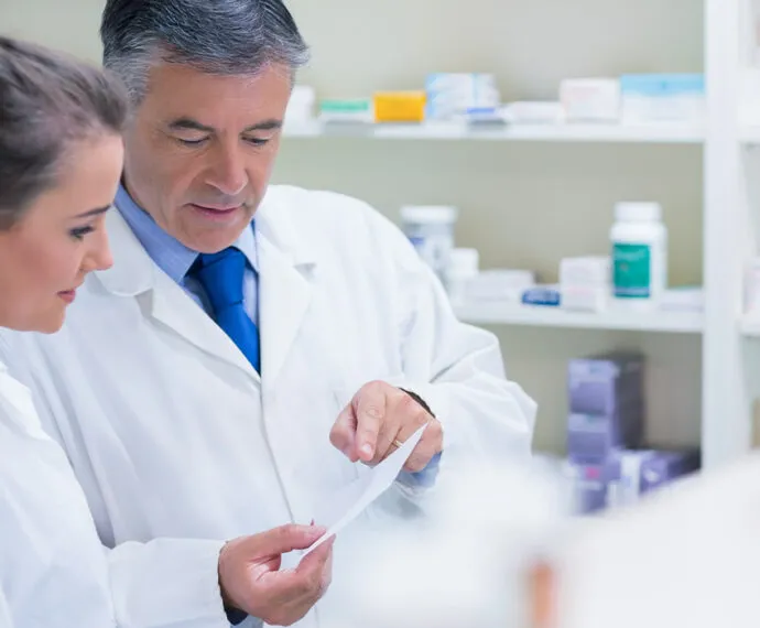 Pharmacist explaining a prescription to his trainee