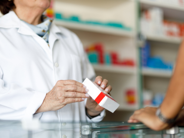 pharmacist showing medication to patient